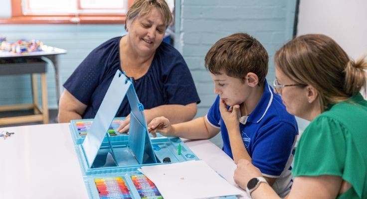 Principal, SLSO and student sit together to support the students learning.